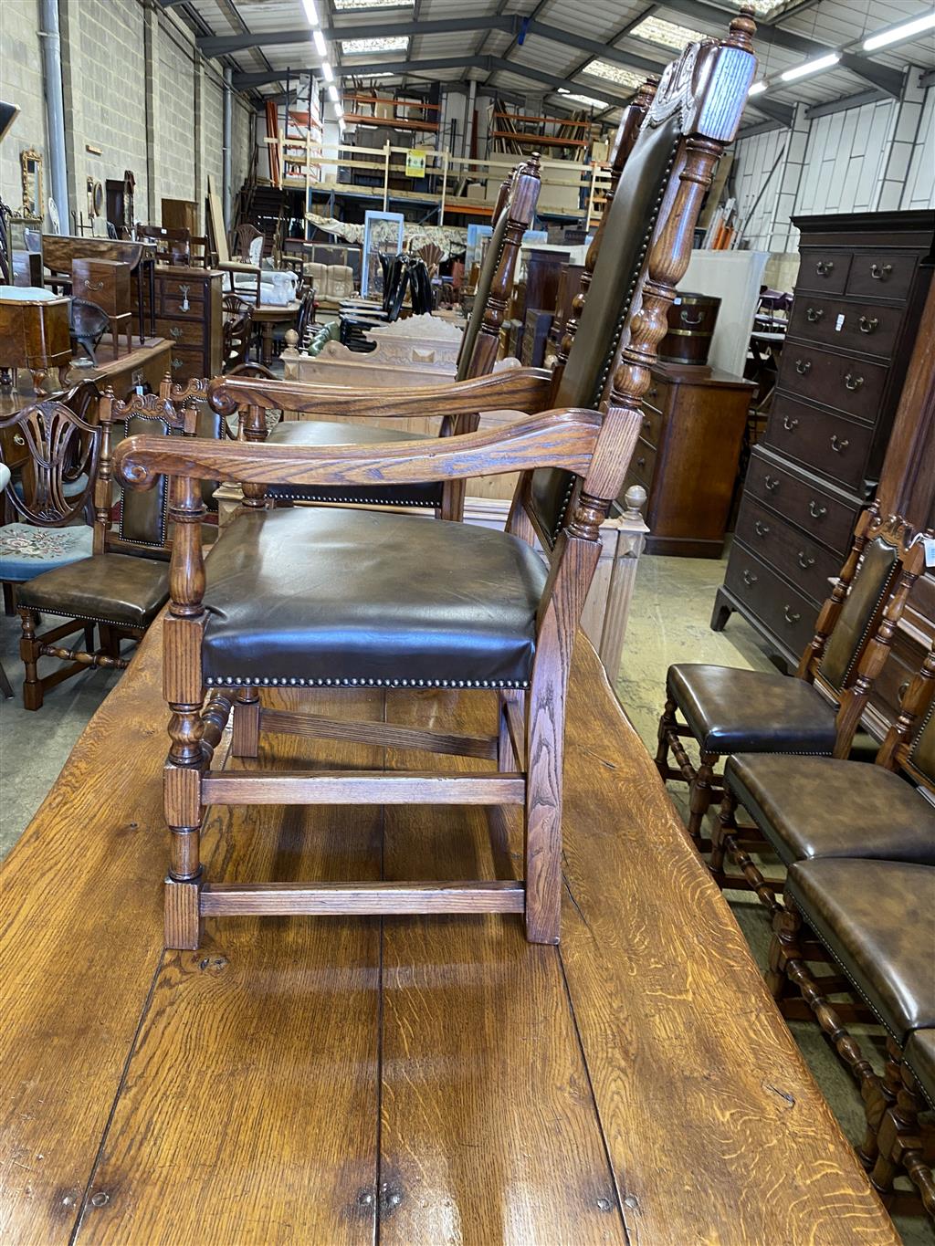 A set of ten 18th century style oak brown leather dining chairs (two with arms)